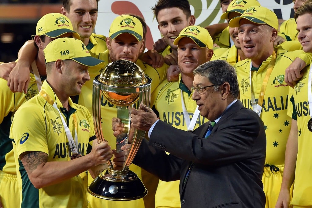 ICC chairman Narayanaswami Srinivasan presents the 2015 Cricket World Cup trophy to Australia captain Michael Clarke on March 29. Photo: AFP