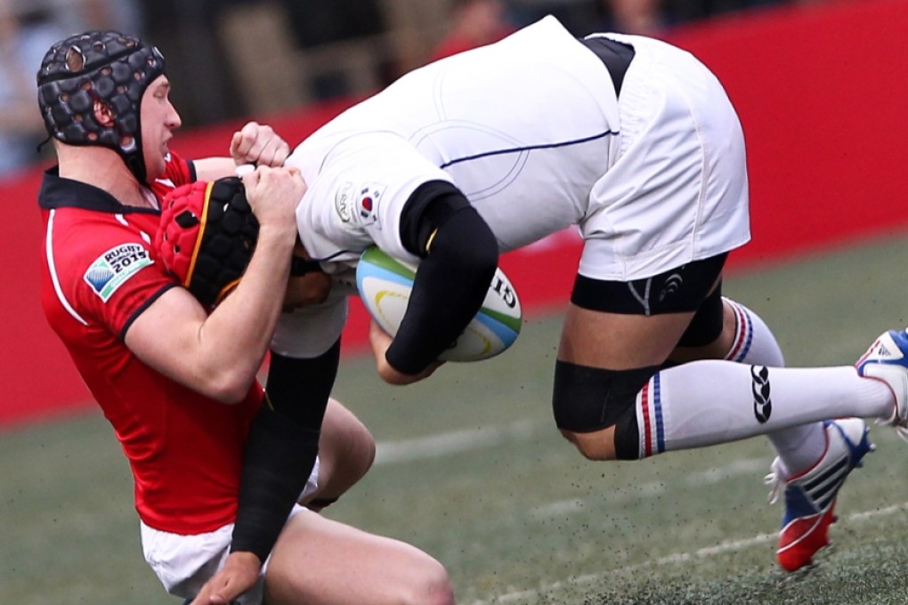 Hong Kong's Christopher McAdam tackles South Korean number eight Lee Kwang-moon during their 2014 Asian Five Nations clash at HKFC. Photo: Jonathan Wong/SCMP