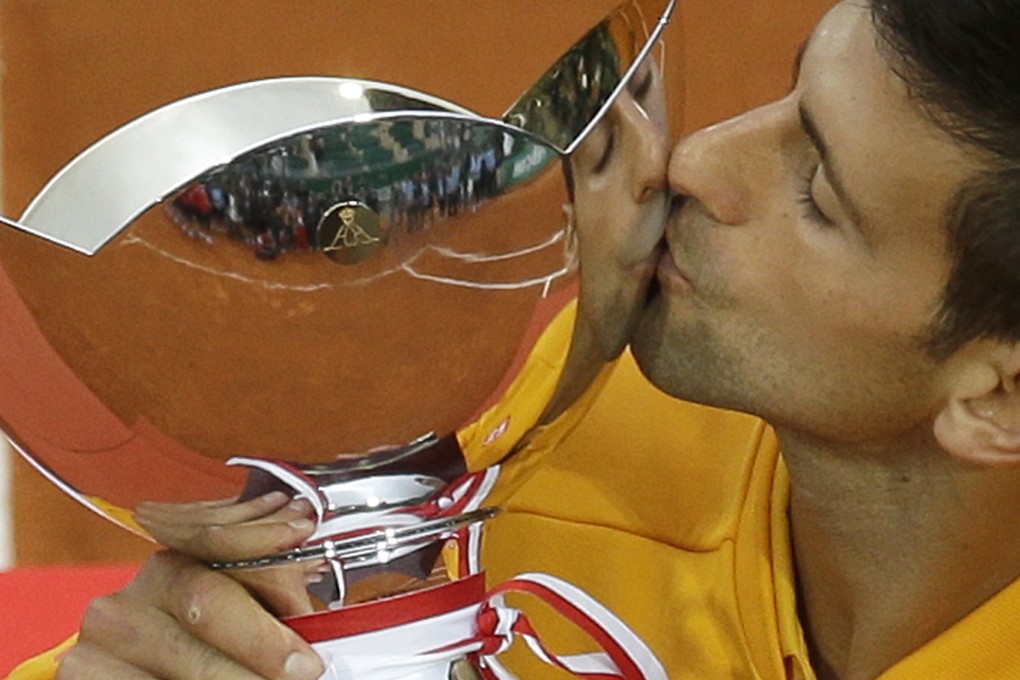Novak Djokovic kisses his trophy after defeating Thomas Berdych of Czech Republic. Photo: AP
