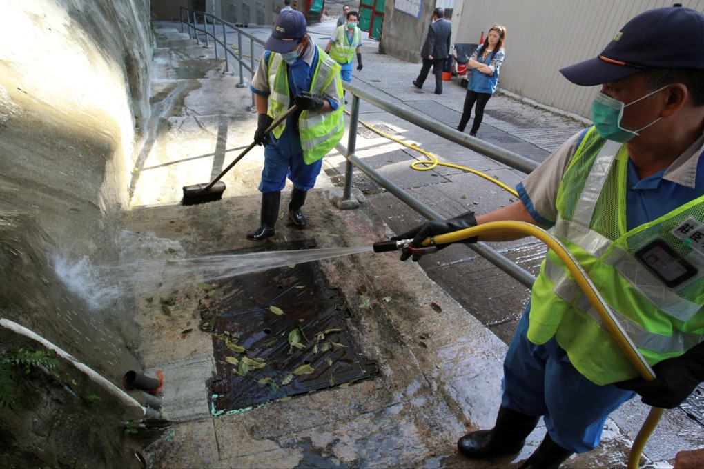 Food, Health and Environmental Hygiene Department contractors have been hosing down the site of a sewage leak in North Point for more than a month. Photo: Dickson Lee
