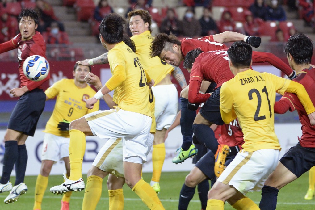 Kashima Antlers forward Hiroyuki Takasaki (centre in red) heads in a last-gasp winner in Guangzhou Evergrande's most recent AFC Champions League fixture. Photo: Kyodo