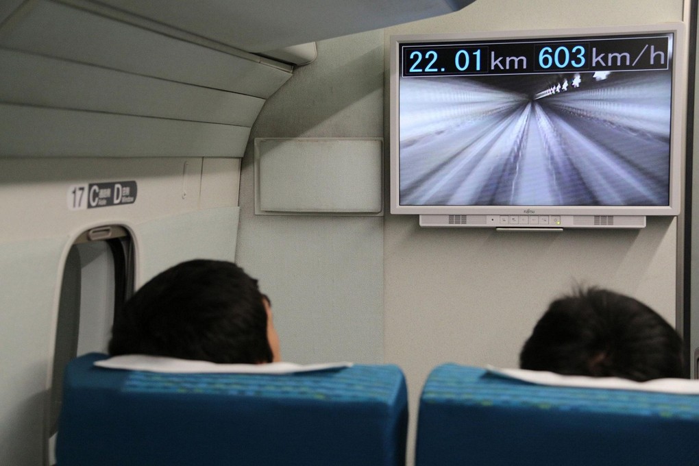 Passengers watch a monitor in the seven-car maglev train as it speeds up to set a world record in a test run on a track near Mount Fuji yesterday. Photo: AFP