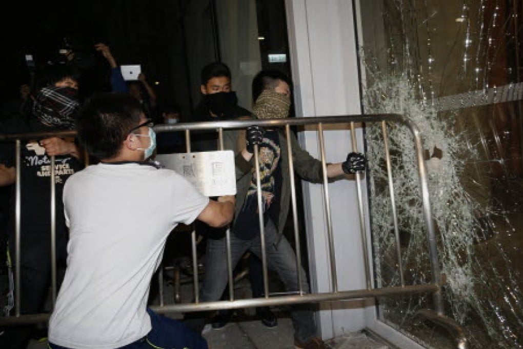 Occupy protesters broke windows at Legco in November. Photo: Reuters