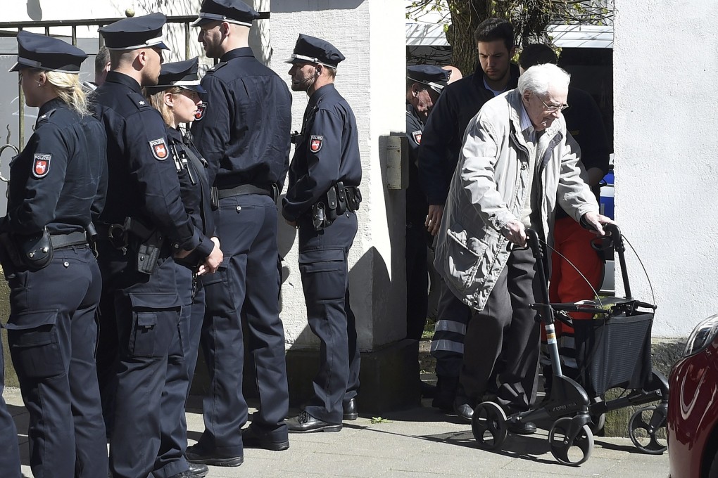 Defendant Oskar Groening leaves court after the first day of his trial in Lueneburg, Germany, on Tuesday. Photo: Reuters