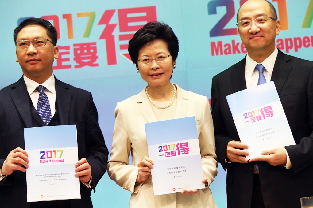 (From left) Secretary for Justice Rimsky Yuen, Chief Secretary Carrie Lam and Secretary for Constitutional and Mainland Affairs Raymond Tam pose with promotional leaflets on 2017 political reform during a news conference in Hong Kong. Photo: K.Y. Cheng