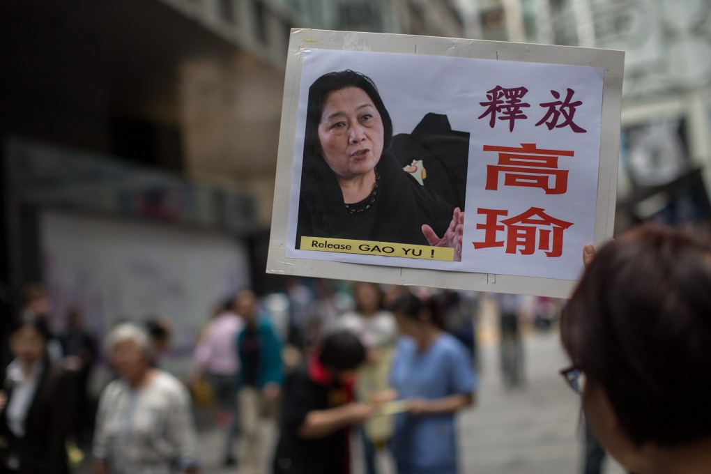 Activists hold pictures of imprisoned Chinese journalist Gao Yu during a signature drive asking for her release in central Hong Kong in April. Photo: EPA