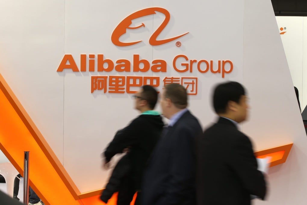 The Alibaba logo looms over passersby in a conference. Photo: EPA