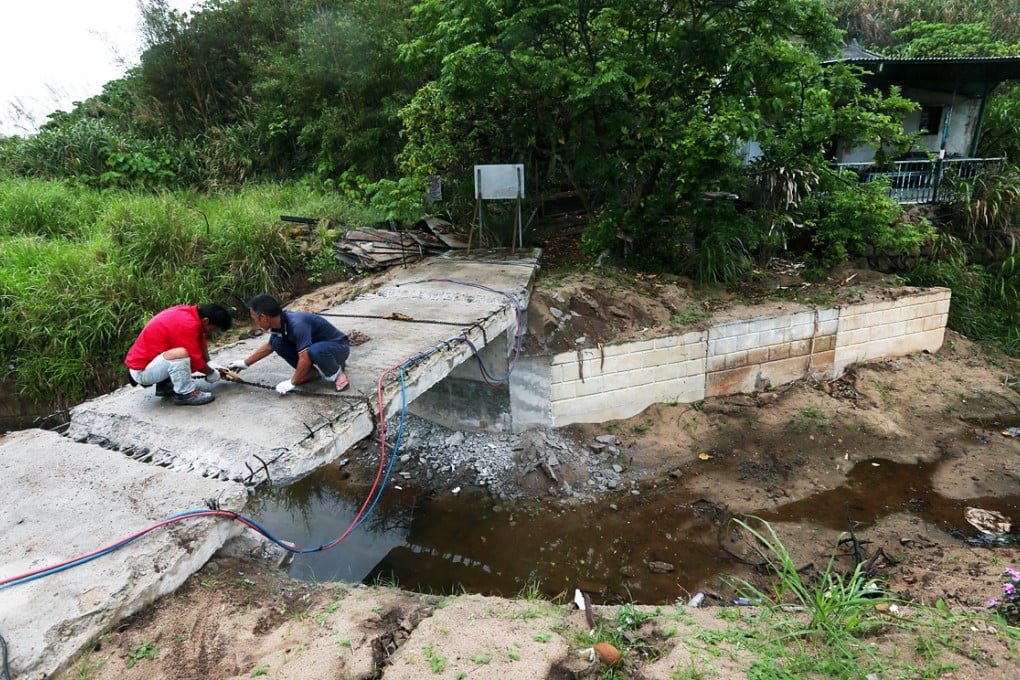 Workers demolish an illegal bridge at Tung O on Lamma Island last year. Photo: Nora Tam