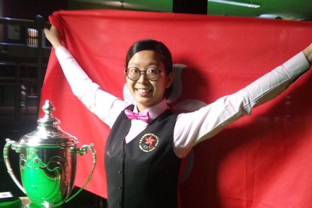 Ng On-yee proudly displays her trophy while carrying the Hong Kong flag after her victory in the women's snooker world championship final. Photos: SCMP Pictures