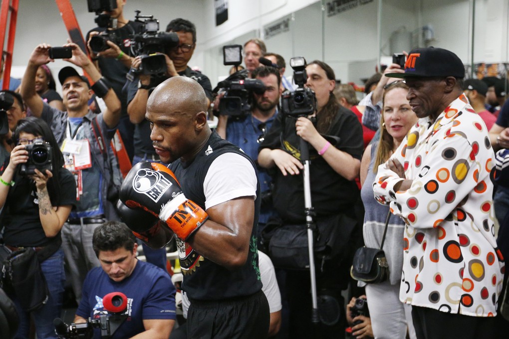 Floyd Mayweather Snr (right) watches his son work out in Las Vegas. Photo: AP