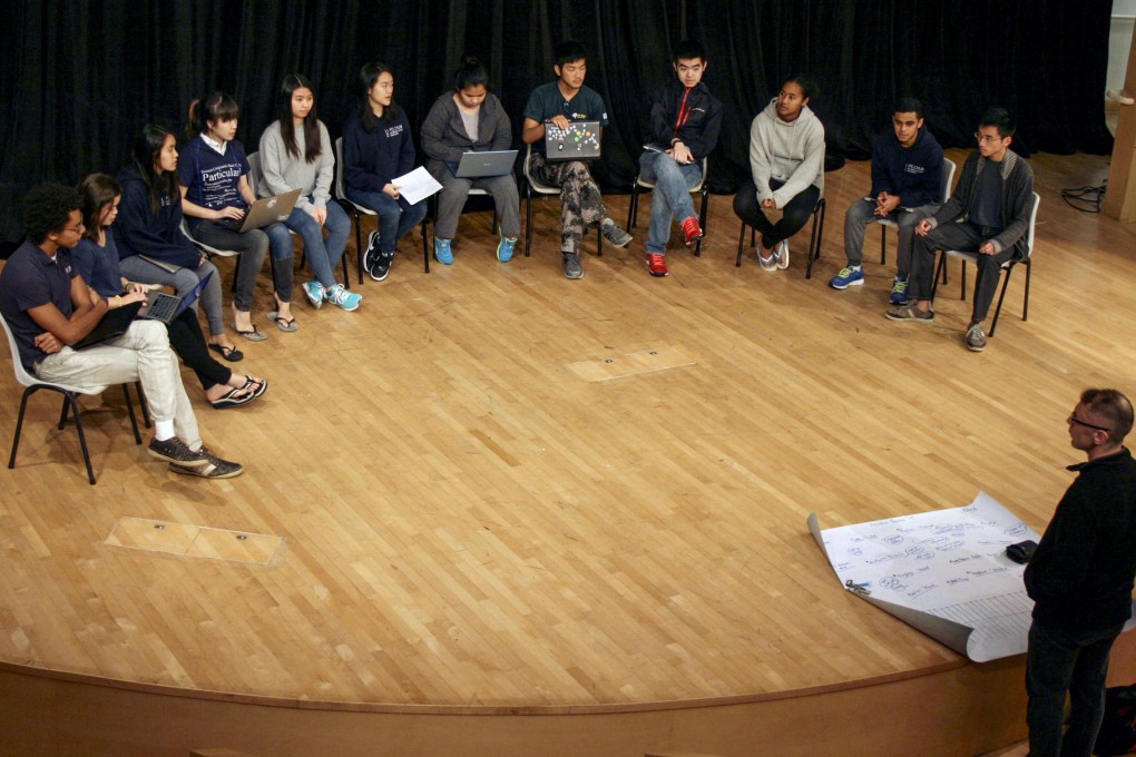 Steve Reynolds discusses the running order for the performance with students from Li Po Chun United World College.