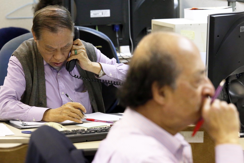investors in the Hong Kong stock market where shares of ASM Pacific Technology rose after it said net profit climbed 82 per cent. Photo: Nora Tam