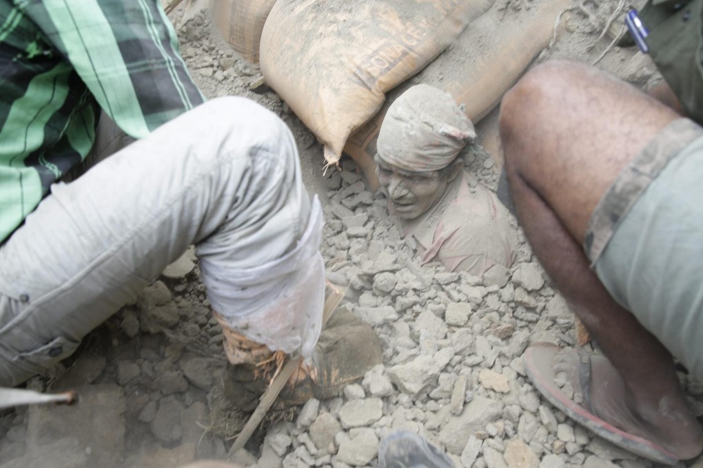 A man stuck in the rubble of a building destroyed by the quake, the most powerful to hit Nepal in more than eight decades. Photo: EPA