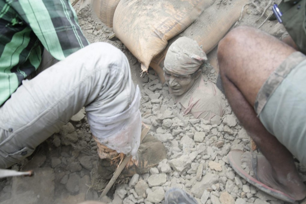 A man stuck in the rubble of a building destroyed by the quake, the most powerful to hit Nepal in more than eight decades. Photo: EPA