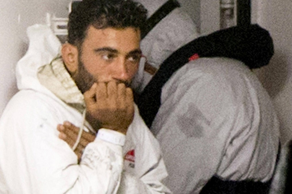 Mohammed Ali Malek, a survivor of the boat that overturned, waits to go ashore in Italy after being rescued by the coastguard. Photo: AP