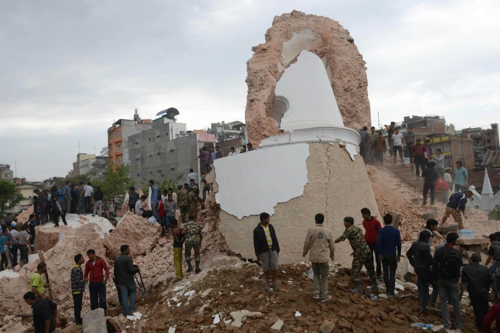 Rescue workers and onlookers at the collapsed Darahara Tower, a key tourist attraction in the heart of Kathmandu's old quarter. Photo: AFP