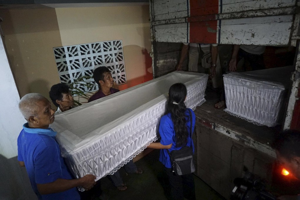 Workers load coffins ready to be taken to a police station near Nusakambangan, where the condemned convicts are. Photo: Reuters