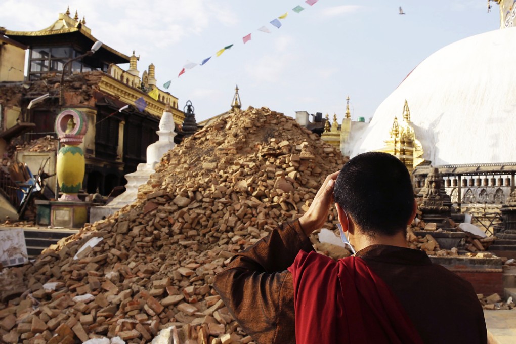 A monk inspects the damage at Nepalese heritage site Syambhunaath Stupa, also known as monkey temple, after a powerful earthquake struck Nepal. Photo: EPA