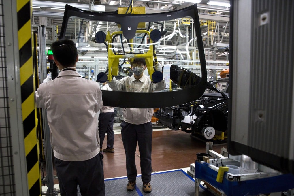 Workers at a BAIC factory in China after the company posted a net profit in the first quarter of 2015. Photo: AP