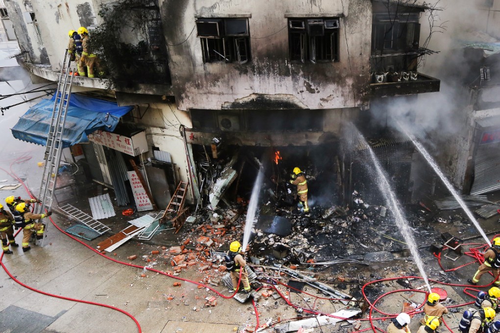 Firemen try to put out a fire at the explosion scene on Sunday. Photo: Sam Tsang