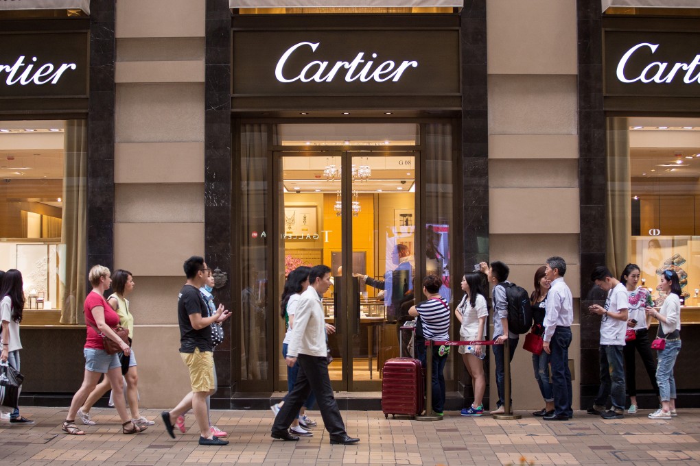 Shoppers line up outside a Cartier store in the Tsim Sha Tsui district of Hong Kong. The fall in mainland Chinese tourists has them going to Tokyo, Seoul or Taipei to buy luxury items from stores like Cartier over there. Photo: Bloomberg