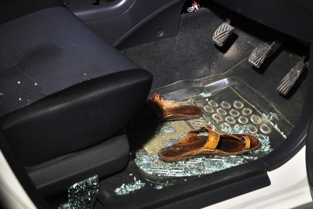 Sandals sit in broken glass in the car in which human rights activist Sabeen Mahmud was shot to death by gunmen on a motorcycle. Photo: AP