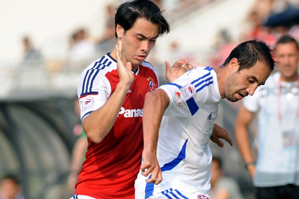 Andy Naegelein shields the ball against South China. Photo: Xinhua