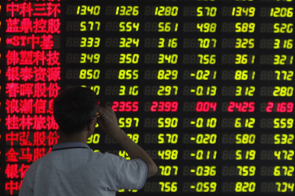 An investor reads financial information at a brokerage in Shanghai. Media reports have suggested investors have little interest in buying municipal bonds coming on the market in China. Photo: Reuters