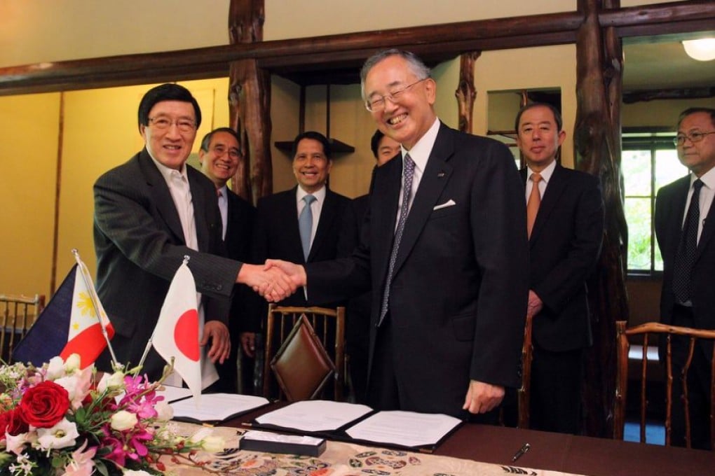 Metrobank Group chairman Dr George SK Ty (left) shakes hands with ORIX Corp chairman Yoshihiko Miyauchi