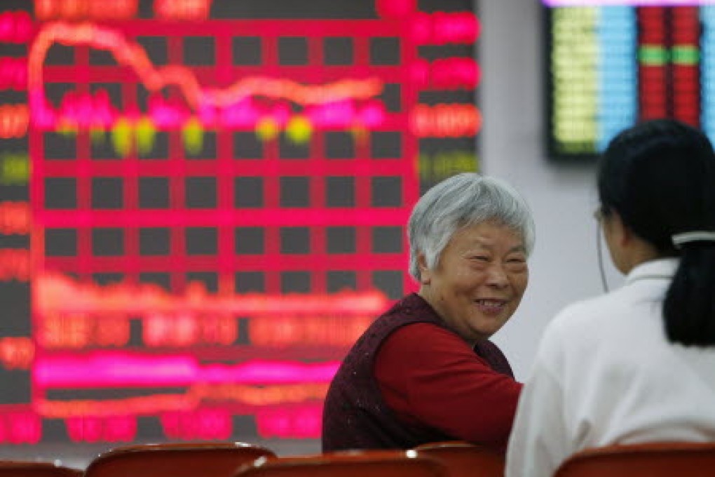 An investor tracks stock market data in Shanghai. Shares markets have been rising in China, despite lacklustre national economic data. Photo: Xinhua