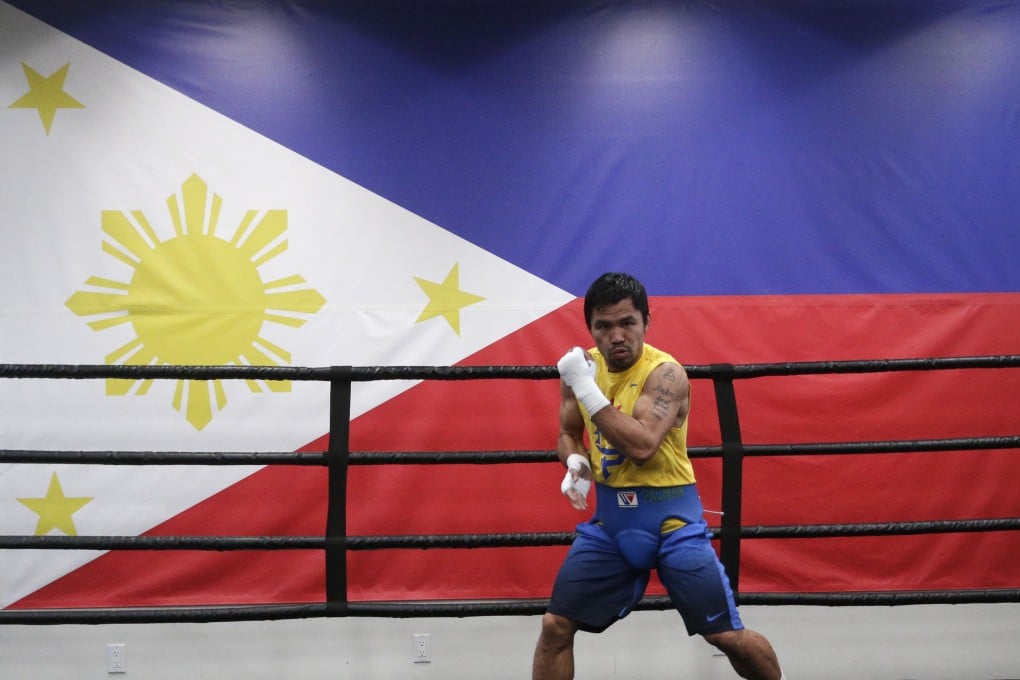 Manny Pacquiao trains at the Wild Card gym in Hollywood in front of a giant Philippines flag. Photo: AP