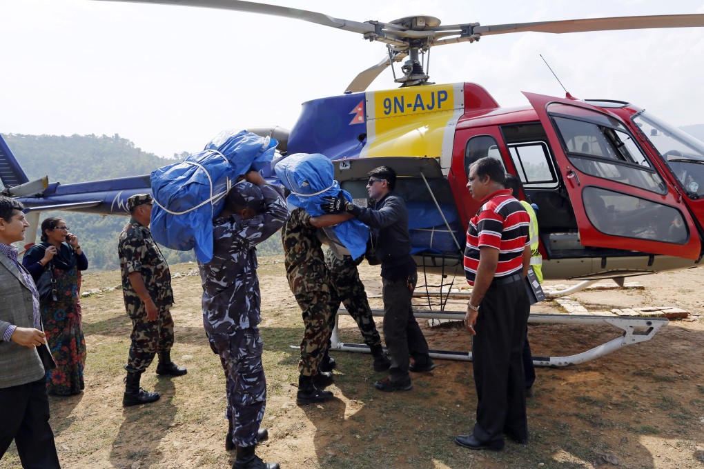 A helicopter is loaded with supplies at a relief staging area in the town of Gorkha, near the quake's epicentre. Photo: AP