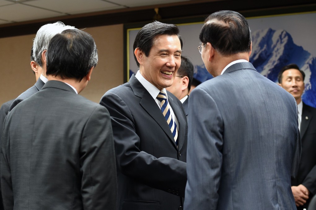 Taiwan President Ma Ying-jeou shakes hands with officials at the Mainland Affairs Council in Taipei on Wednesday. Ma defended his "one China" policy, saying it has brought peace to the Taiwan Strait. Photo: AFP