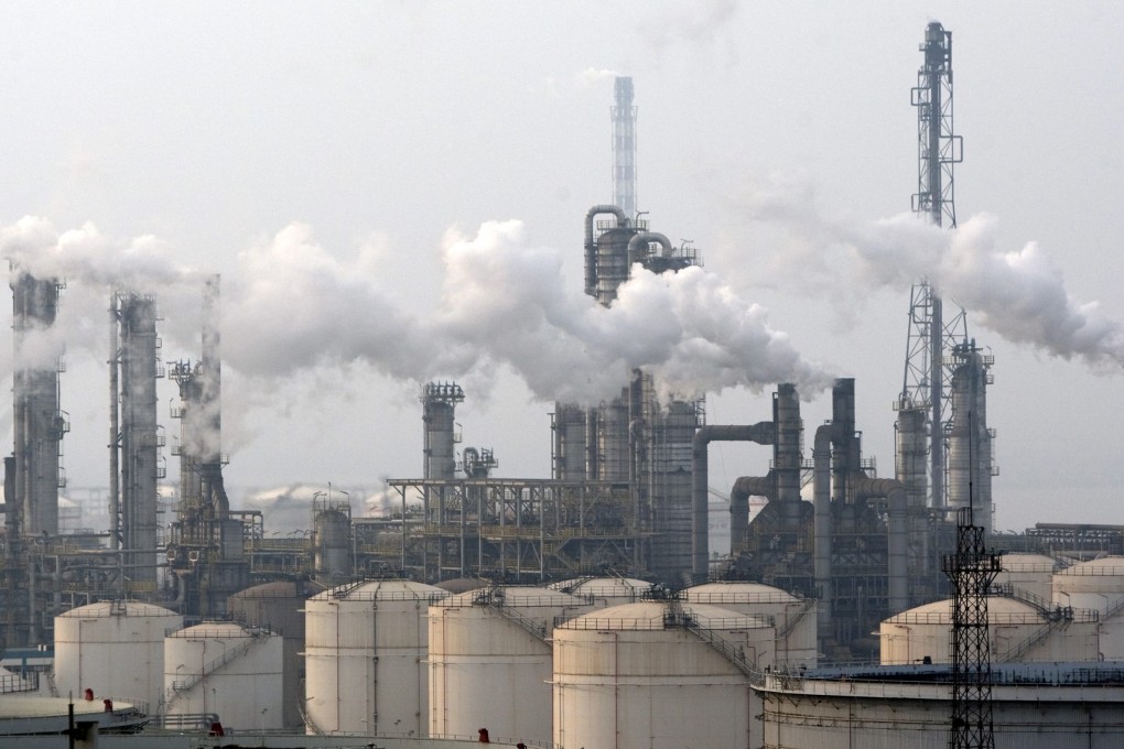 Pollution hangs over factories in Qingdao in eastern China. Premier Li Keqiang last week criticised the excessive delays and costs incurred by some risk assessments. Photo: EPA