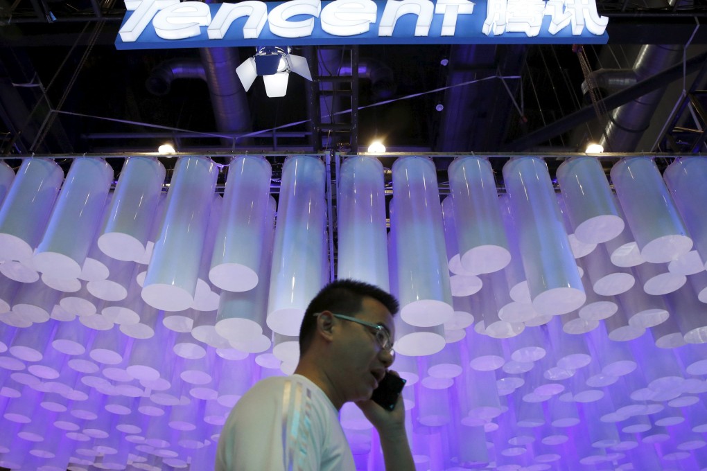 A man uses his phone at the Global Mobile Internet Conference in Beijing, where Tencent unveiled its new smart device operating system. Photo: Reuters