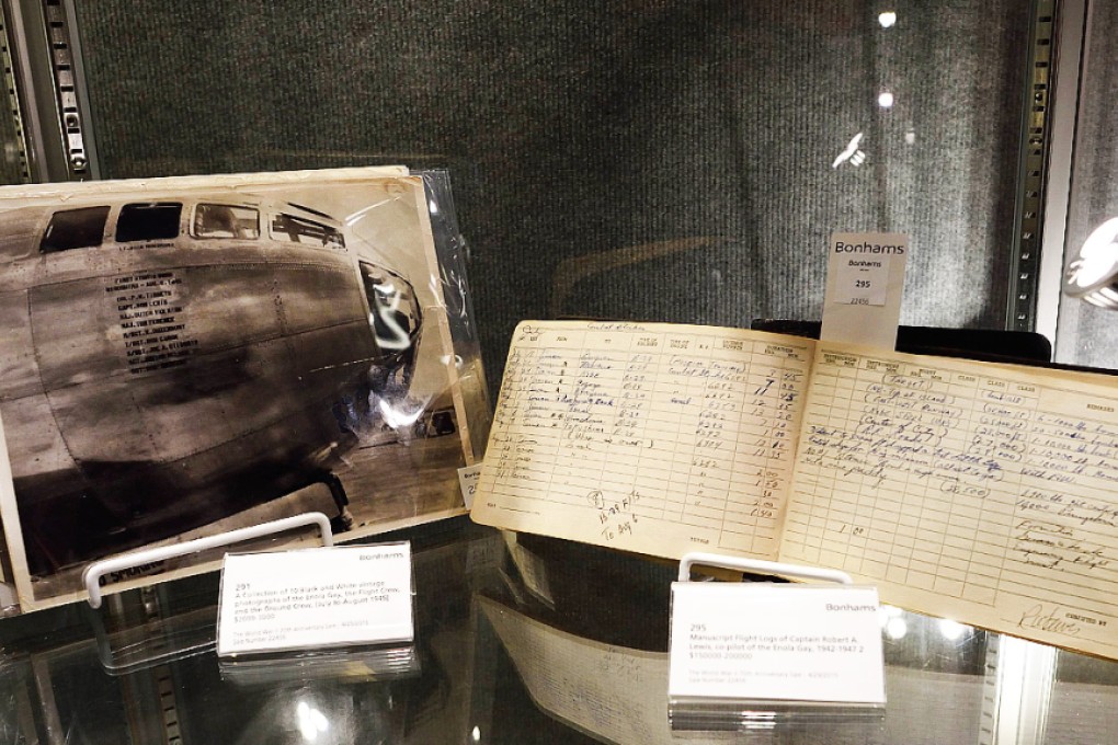 A photo of the Enola Gay and the flight logs of co-pilot Captain Robert Lewis are displayed at Bonhams auction house. Photo: AFP