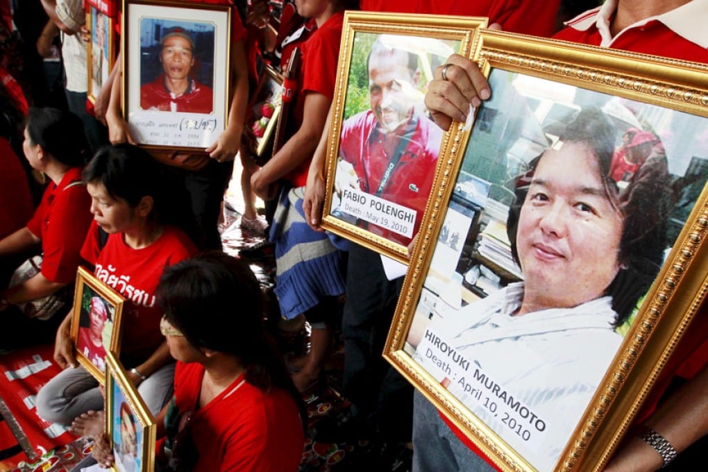 Anti-government ''red shirt'' protesters hold pictures of people who died, including Reuters television cameraman Hiroyuki Muramoto (right), during a religious ceremony near the Democracy Monument in Bangkok in this April 10, 2011 file photo. Photo: Reuters