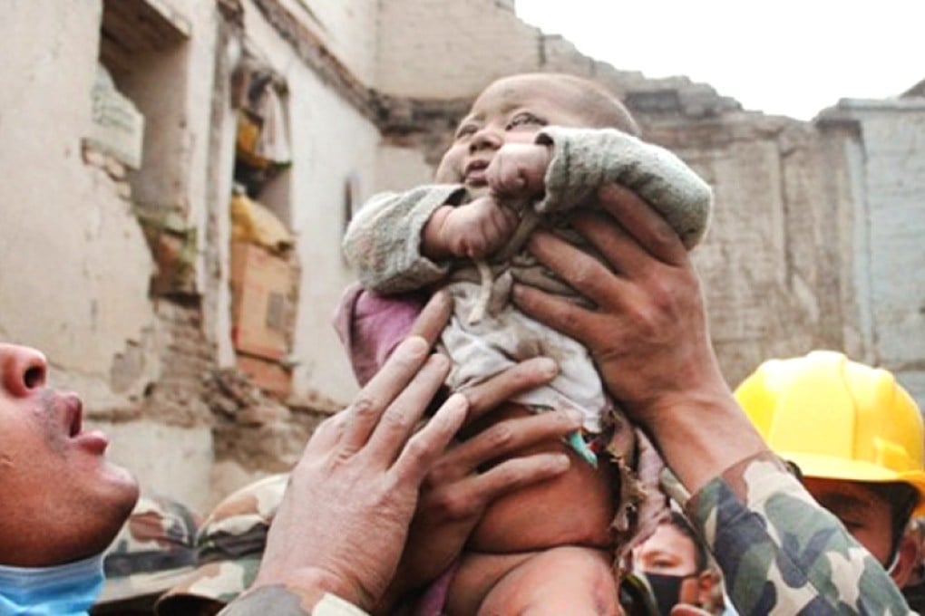 Baby Sonit Awal is rescued from the rubble of his home in Nepal. Photo: Kathmandu Today/ Amul Thapa