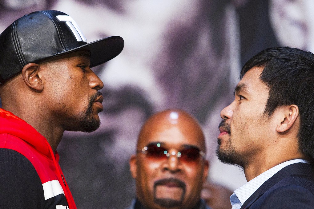 Floyd Mayweather and Manny Pacquiao engage in the traditional stare-down. Photo: Reuters