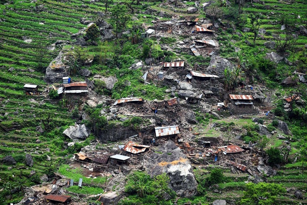 A view of the damage from an Indian Army helicopter, and the body of a woman trapped in the debris of a collapsed house. The UN says the earthquake affected eight million people. Photo: AFP