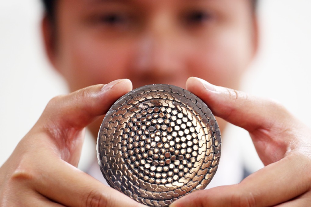 Ngong Ping 360 staff member Jeff Chan Yue-chiu shows a cross-section of cable which will be worked on during the closure. Photo: Felix Wong