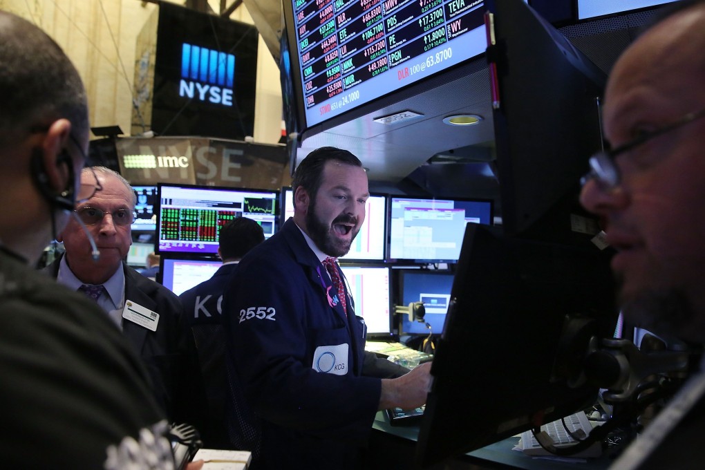Traders in Wall Street react to the policy statement of the US Federal Reserve whose policy statement seemed to indicate any rise in US interest rates may come later than sooner. Photo: AFP