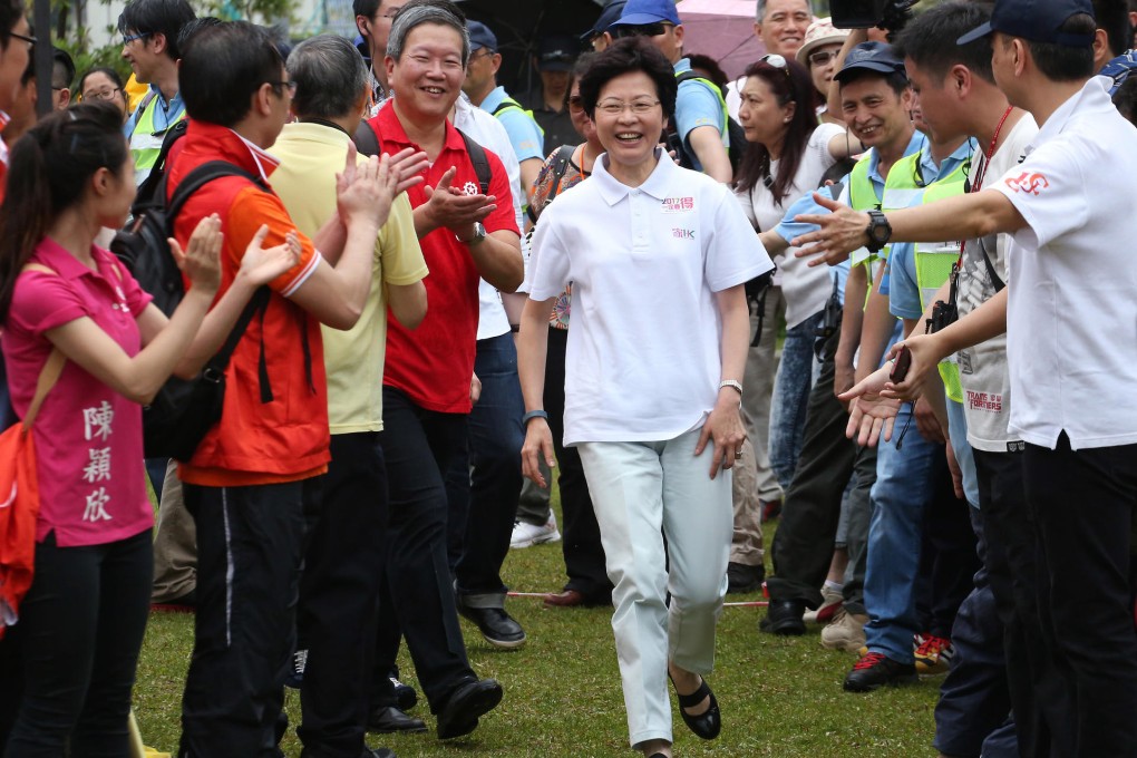 Chief Secretary Carrie Lam receives a warm welcome at the Federation of Trade Unions' Labour Day rally at Tamar Park. Photo: Felix Wong