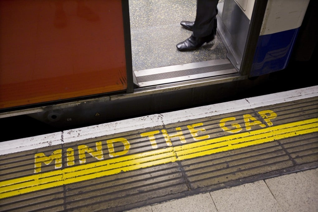 A classic 'Mind the gap' warning sign, painted in noticeable bright yellow, adorns a London Underground train platform.Photo: Corbis
