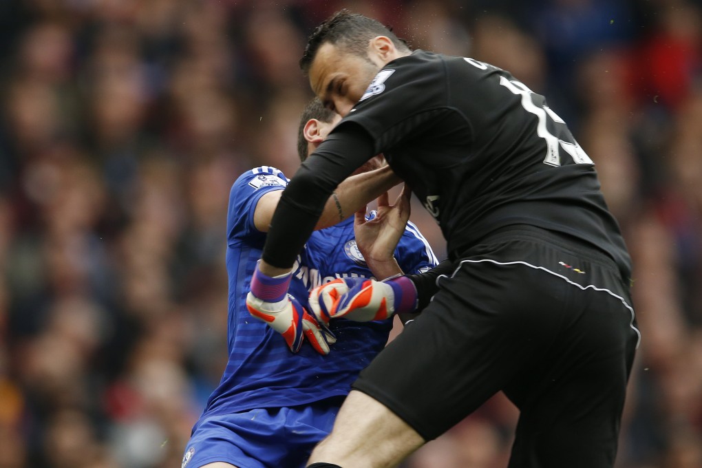 Chelsea's Oscar collides with Arsenal's David Ospina after shooting at goal. Photo: Reuters