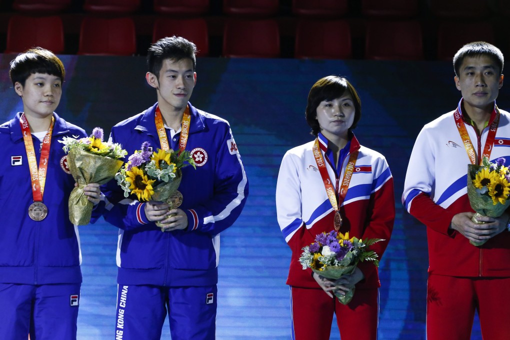 Doo Hoi-kem (left) and Wong Chun-ting of Hong Kong, along with Koreans Kim Jong and Kim Hyok-bong, receive their mixed doubles bronze medals at the World Table Tennis Championships in Suzhou. Photo: EPA