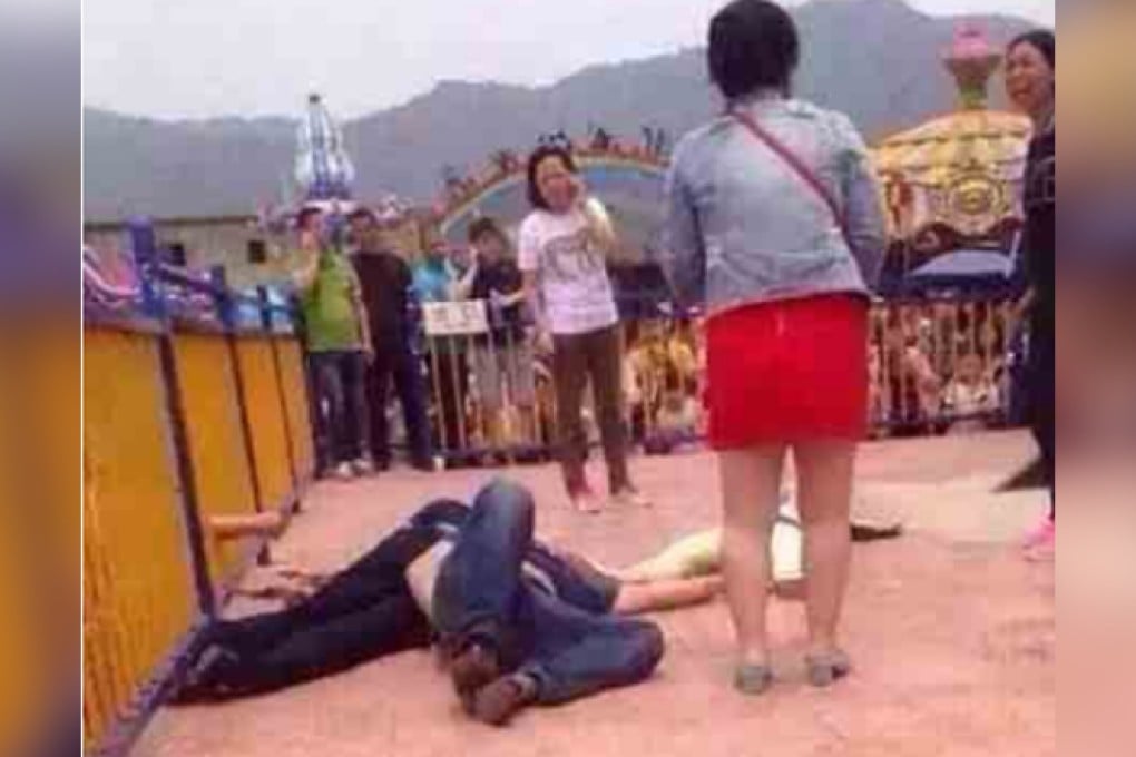 A victim lies on the ground as people around scream for help after the accident at the Zhejiang Pingyang Amusement Park. Photo: SCMP Pictures