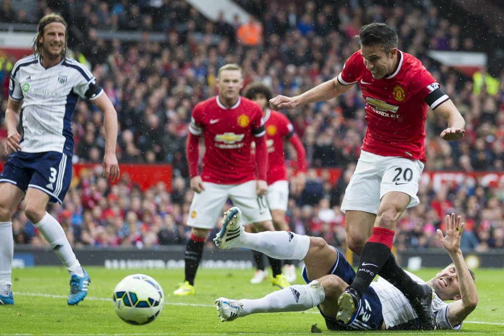 Manchester United's Robin van Persie is tackled by West Brom's Gareth McAuley. Photo: AP