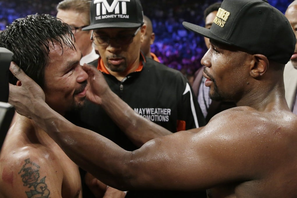 Manny Pacquiao and Floyd Mayweather embrace in the ring at the finish. Photo: AP