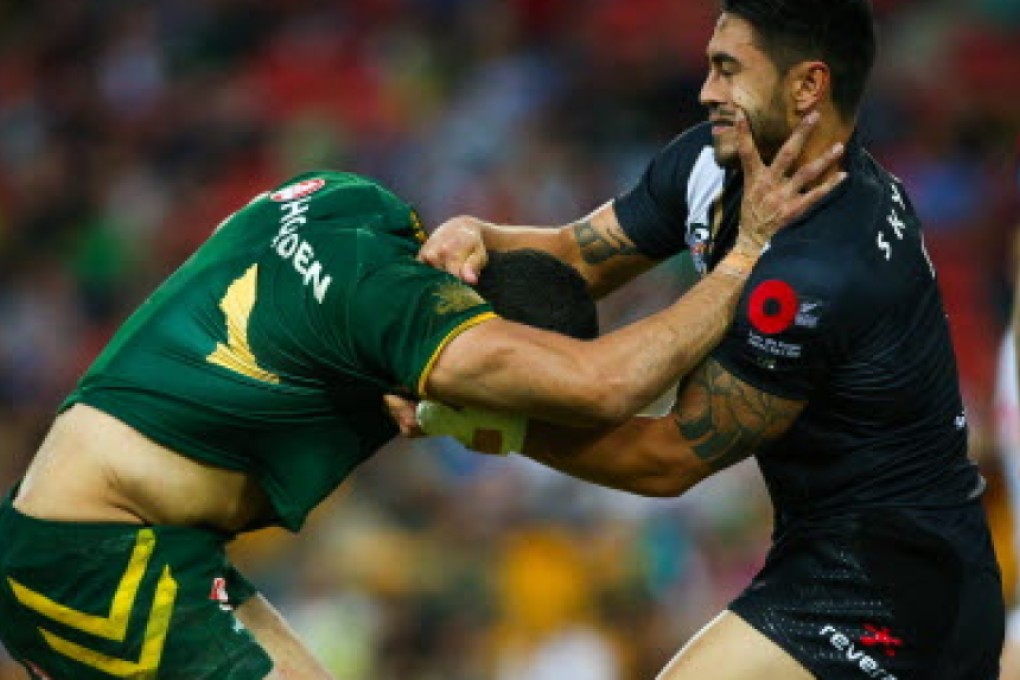 New Zealand's Shaun Johnson tackles Australia's Greg Inglis during their ANZAC rugby league test in Brisbane. Photos: AFP